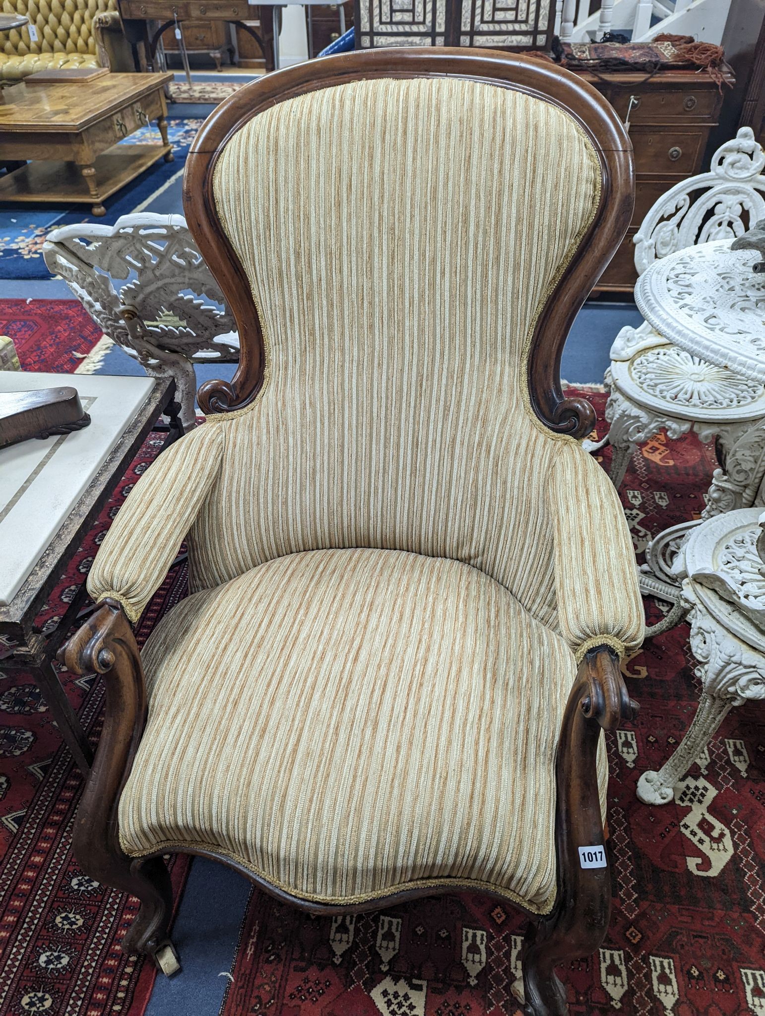 A Victorian upholstered spoon back armchair, width 71cm, depth 74cm, height 102cm